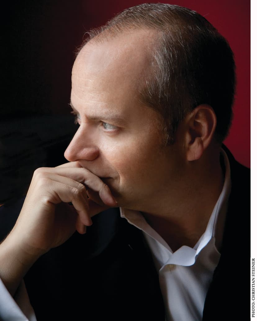 A man in a suit is looking off into the distance