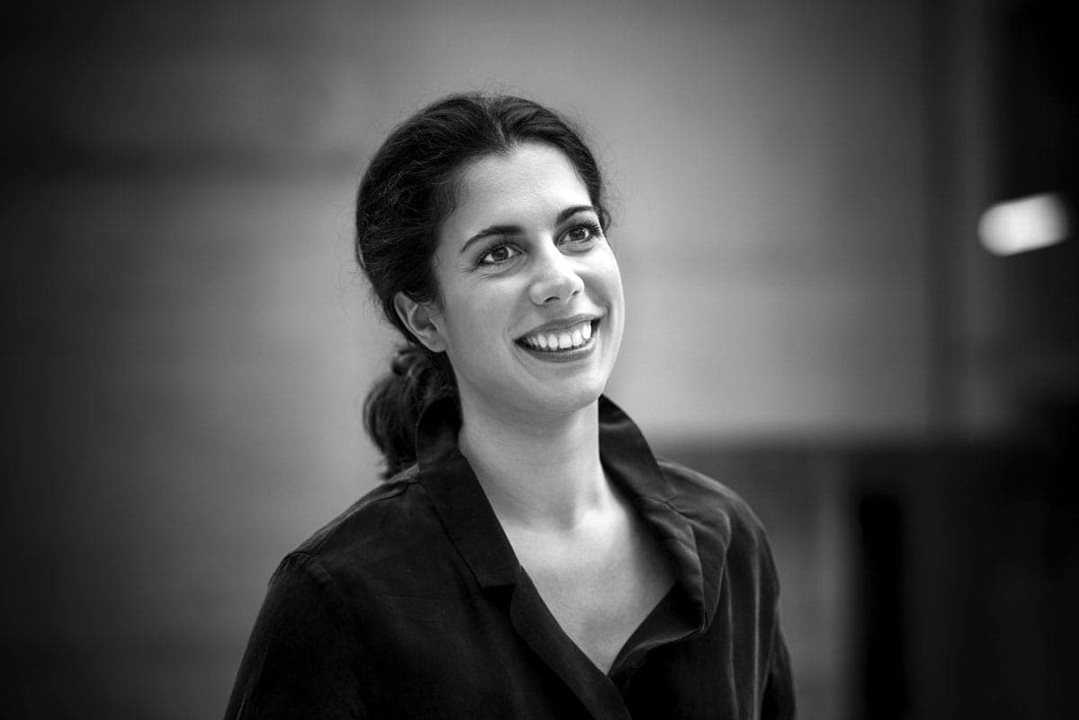 A black and white photo of a woman smiling