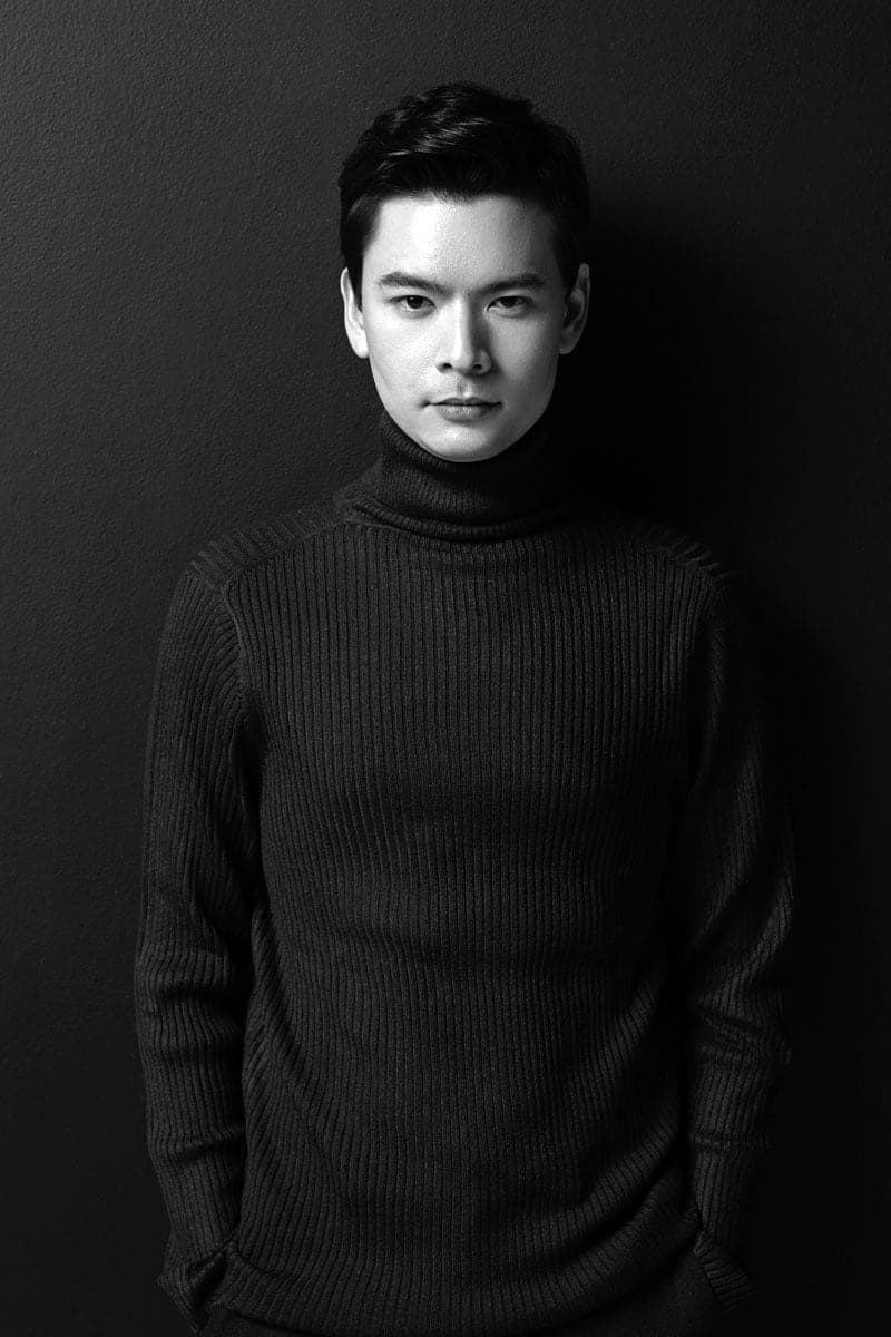 A black and white photo of a young man