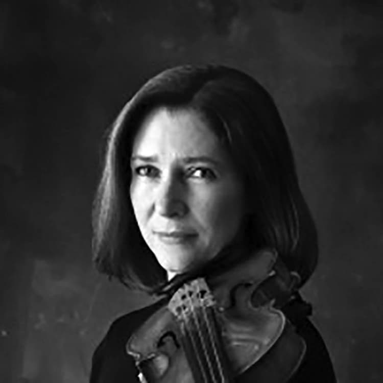 A woman holding a violin in her right hand