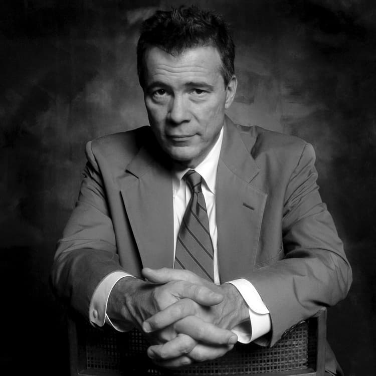 A black and white photo of a man in a suit