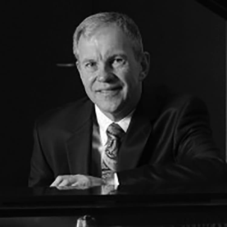 A black and white photo of a man in a suit