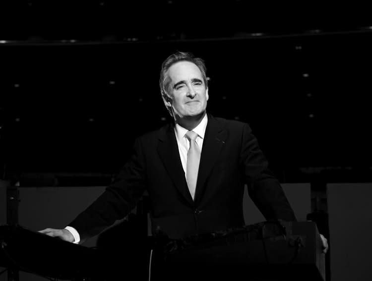 A black and white photo of a man in a suit