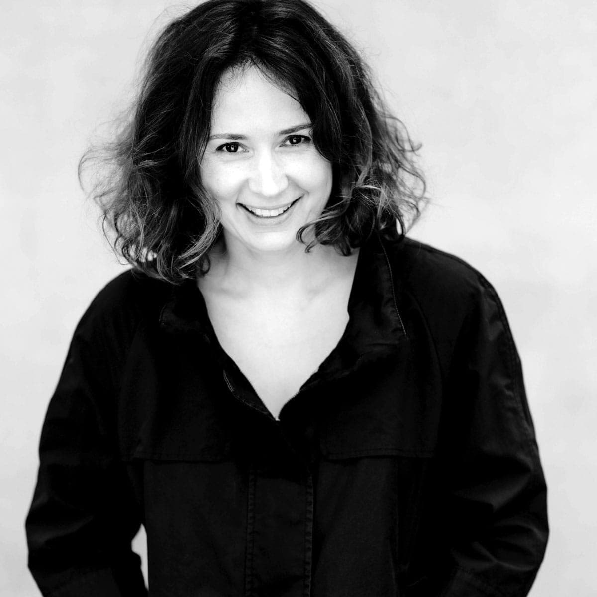 A black and white photo of a woman smiling