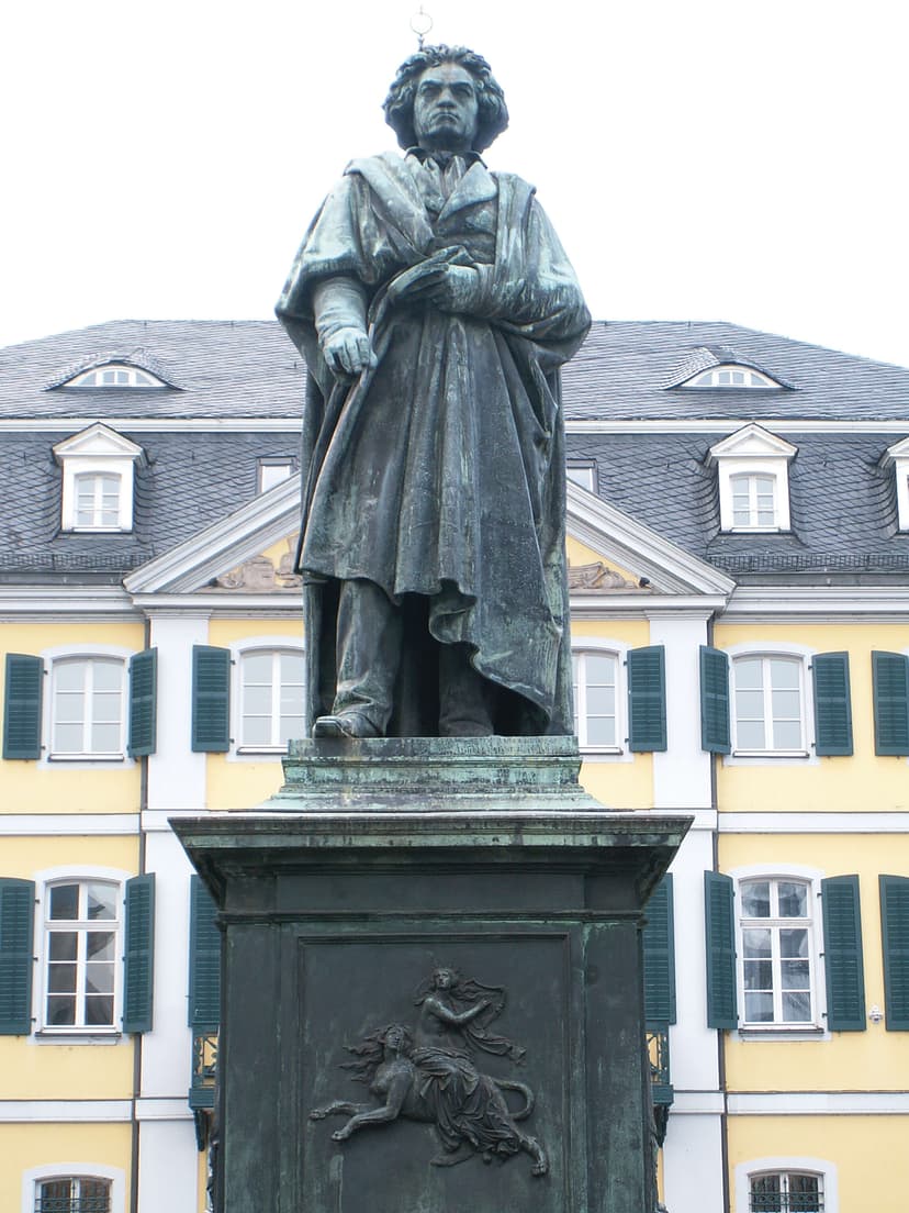 A statue of a man standing in front of a building