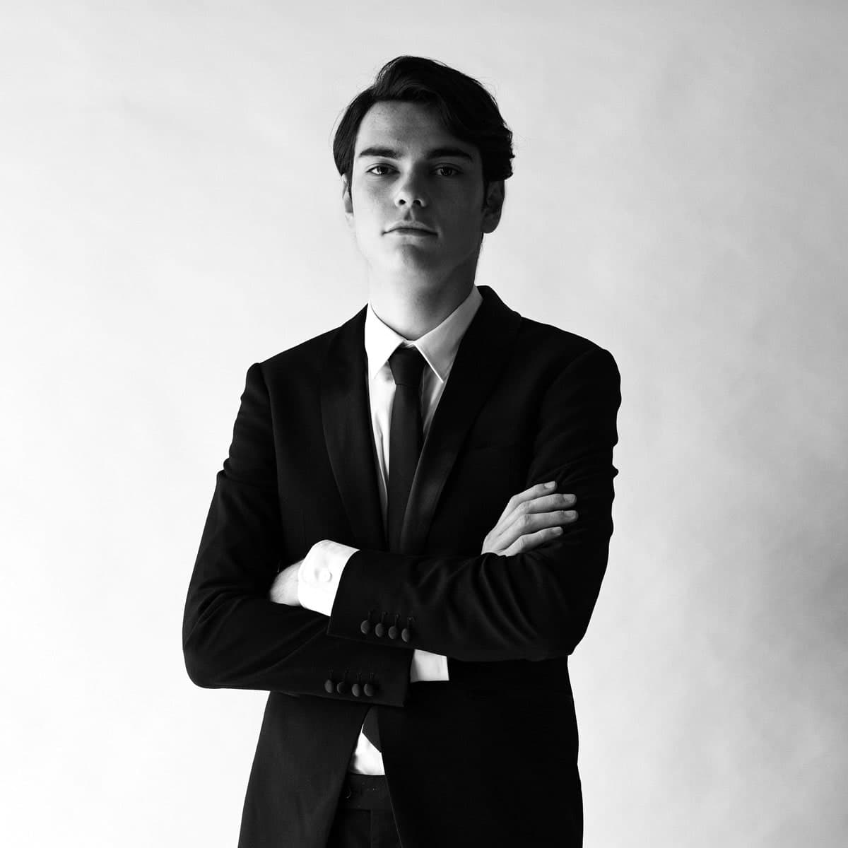 A black and white photo of a man in a suit