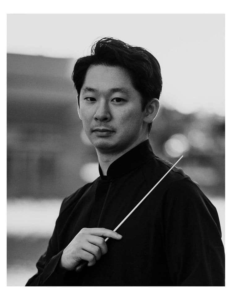 A black and white photo of a man holding an umbrella