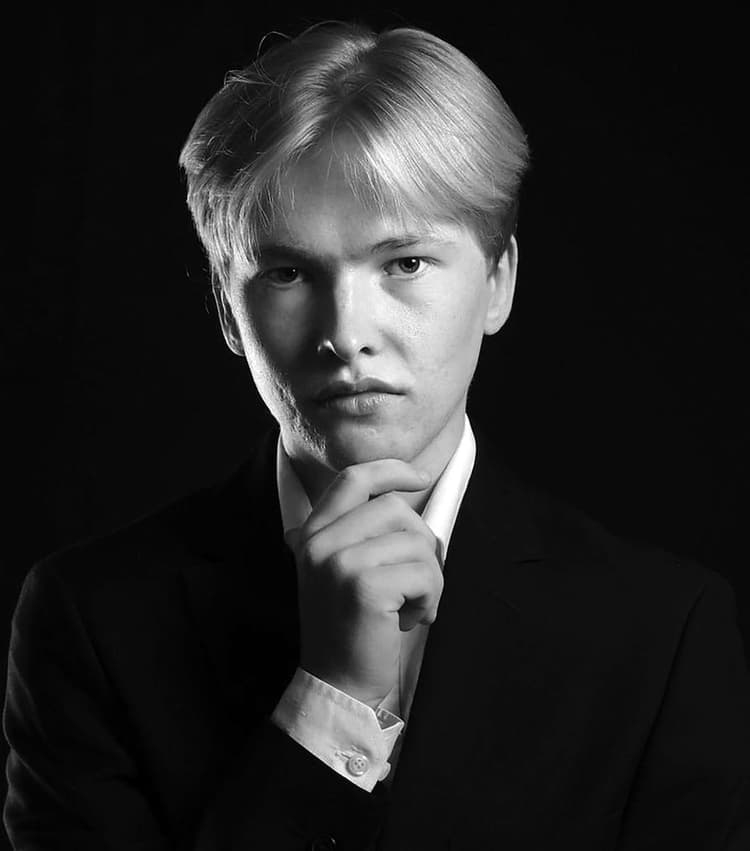 A black and white photo of a man in a suit
