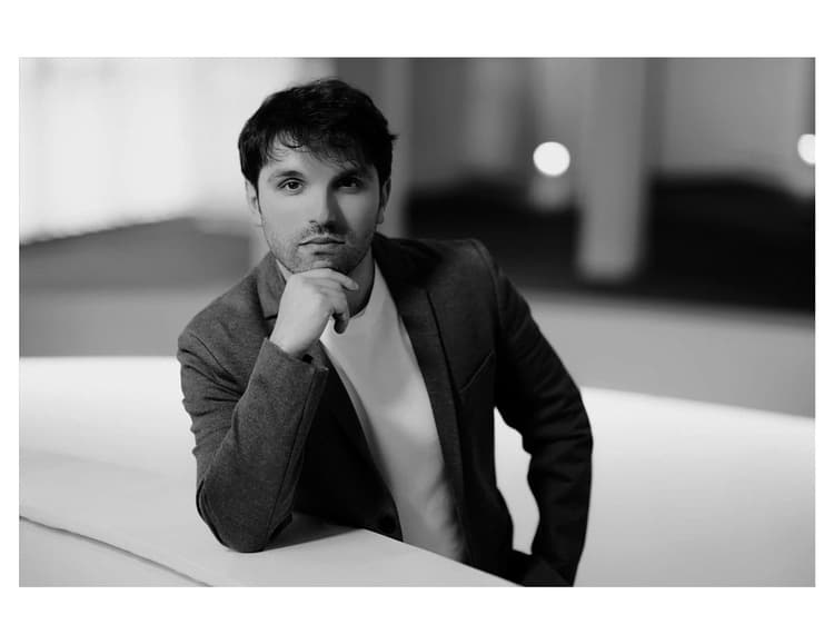 A black and white photo of a man in a suit