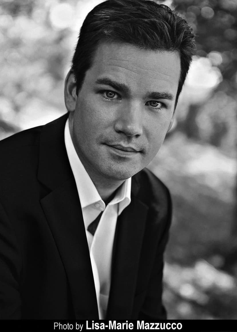 A black and white photo of a man in a suit