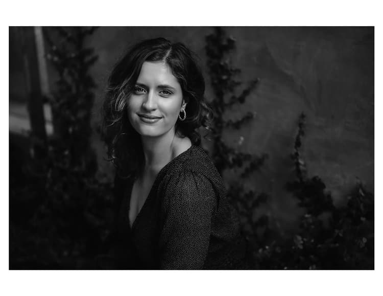 A black and white photo of a woman smiling