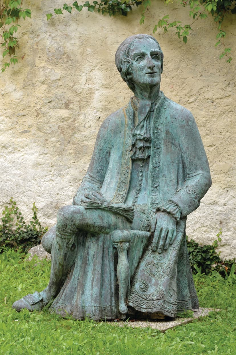 A statue of a man sitting in a chair