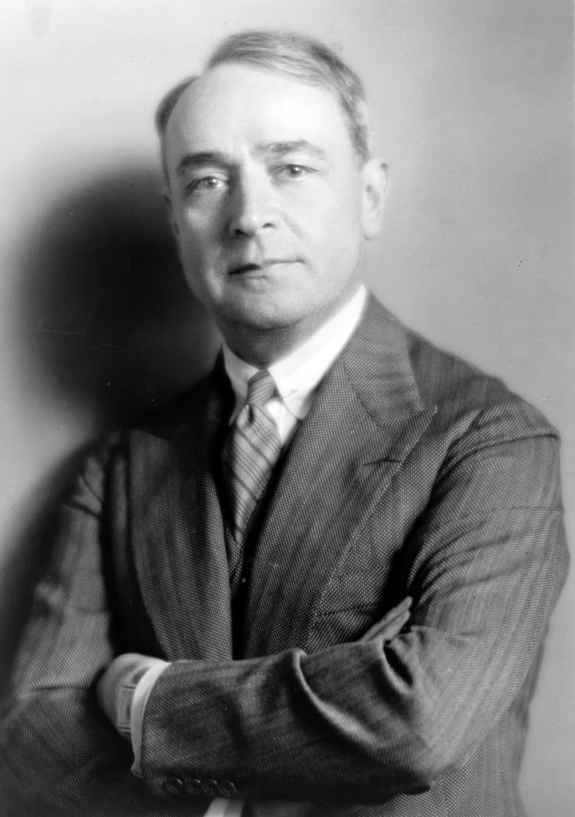 A black and white photo of a man in a suit