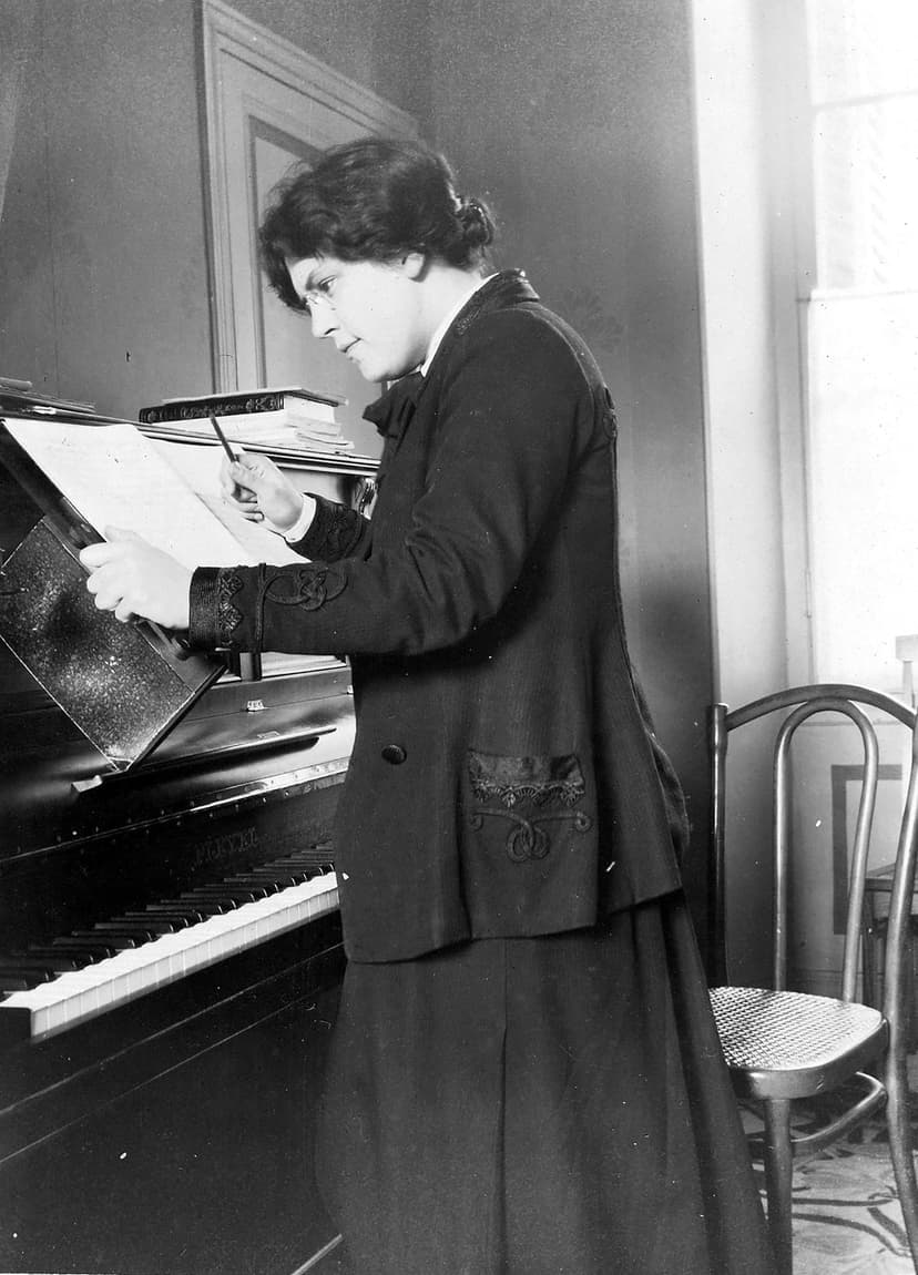 A woman standing in front of a piano