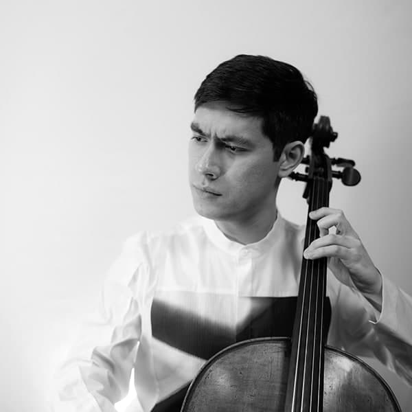 A man holding a cello in his right hand