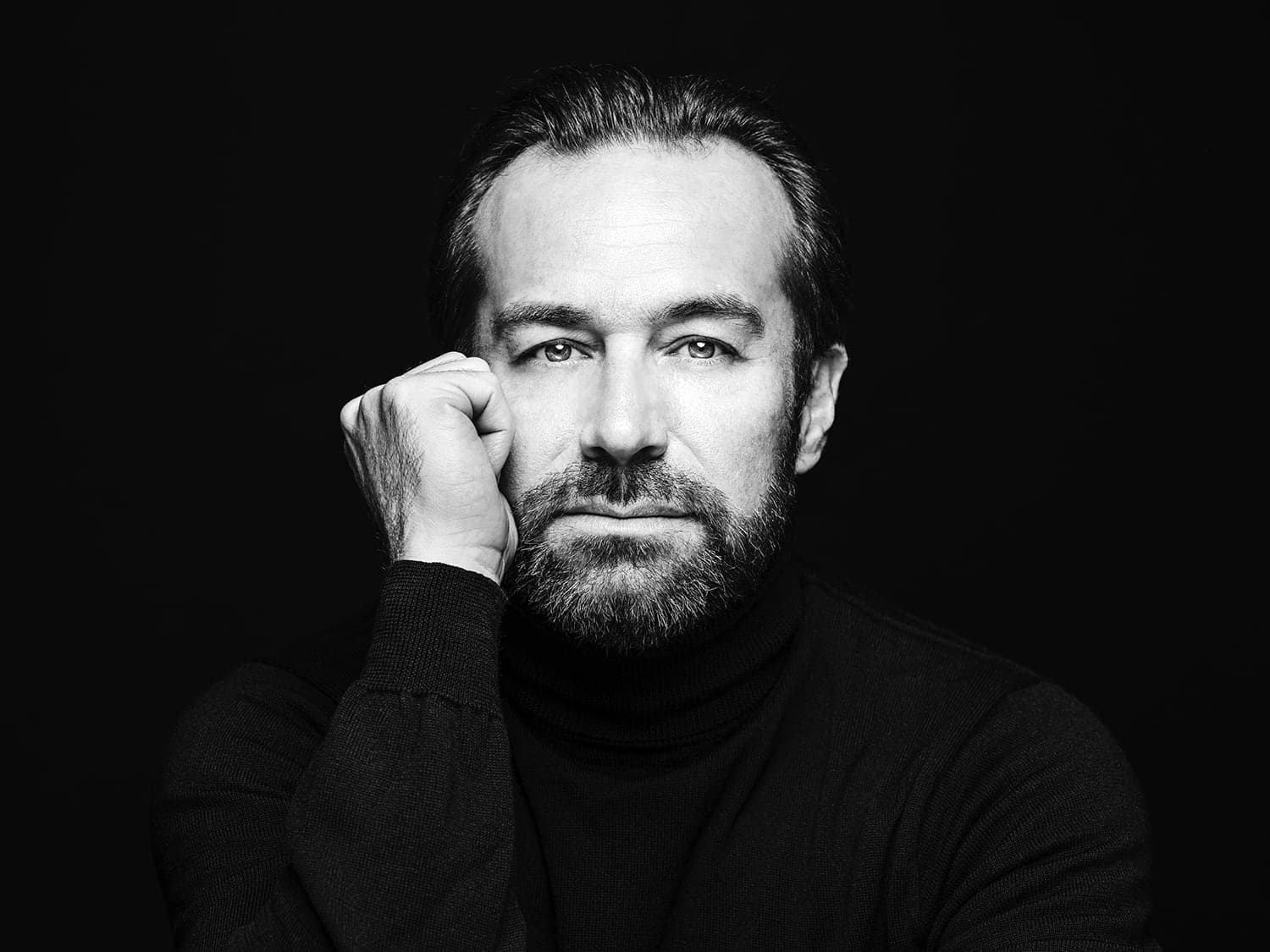 A black and white photo of a man with a beard