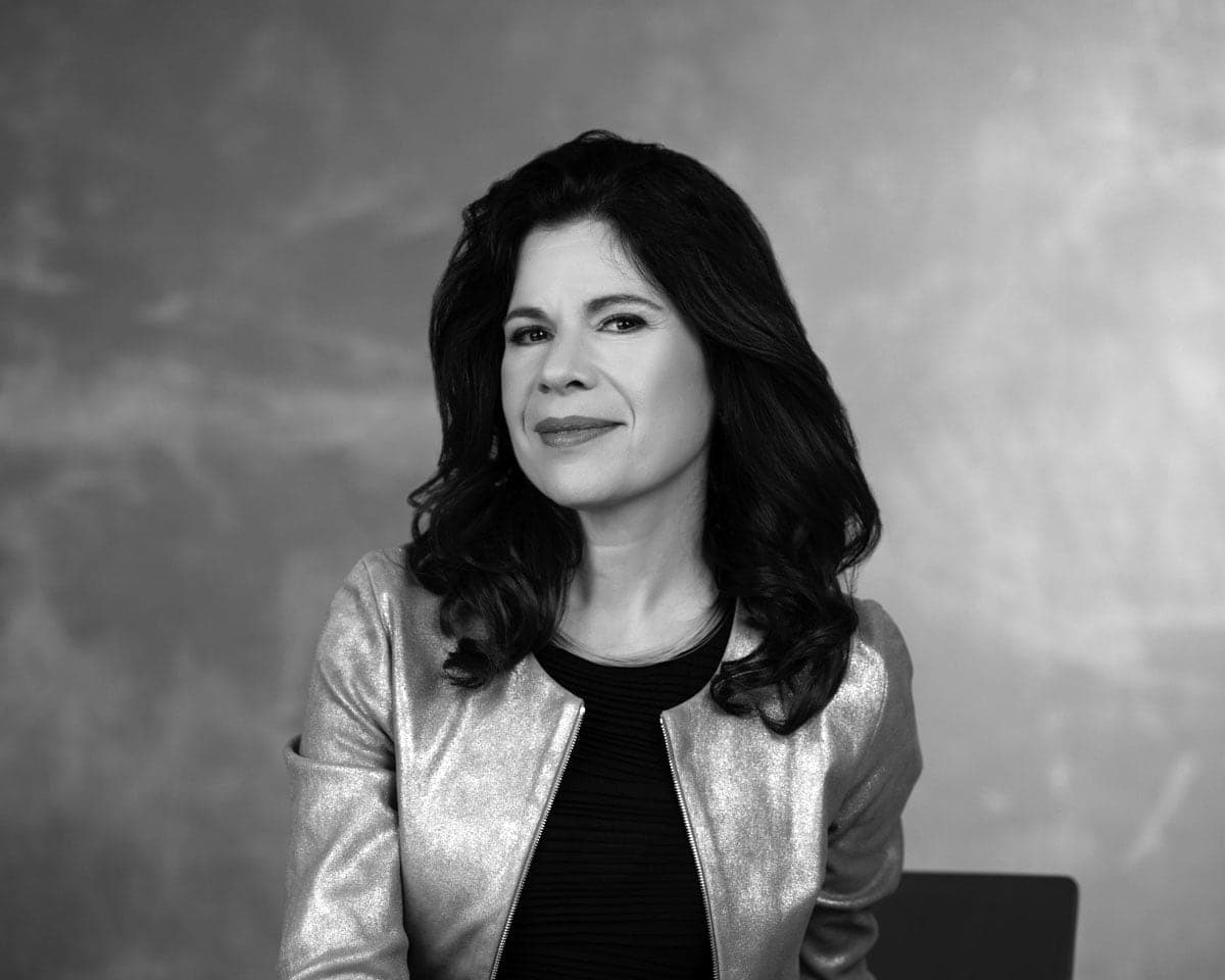 A black and white photo of a woman in a leather jacket