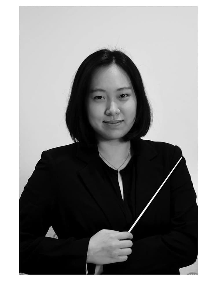 A black and white photo of a woman holding an umbrella