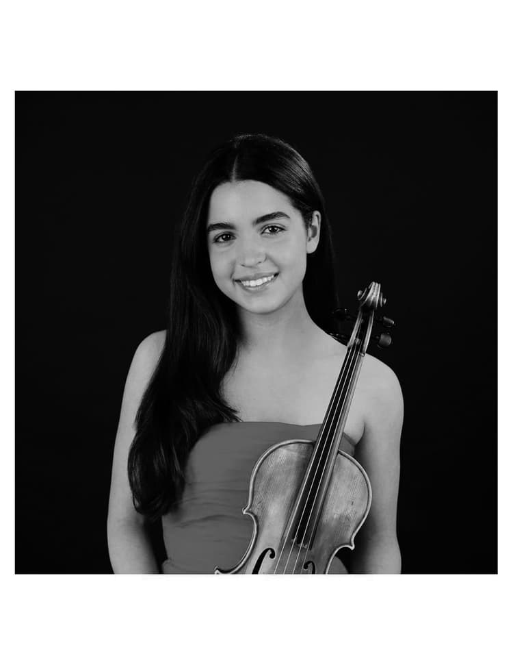 A woman holding a violin in her hands