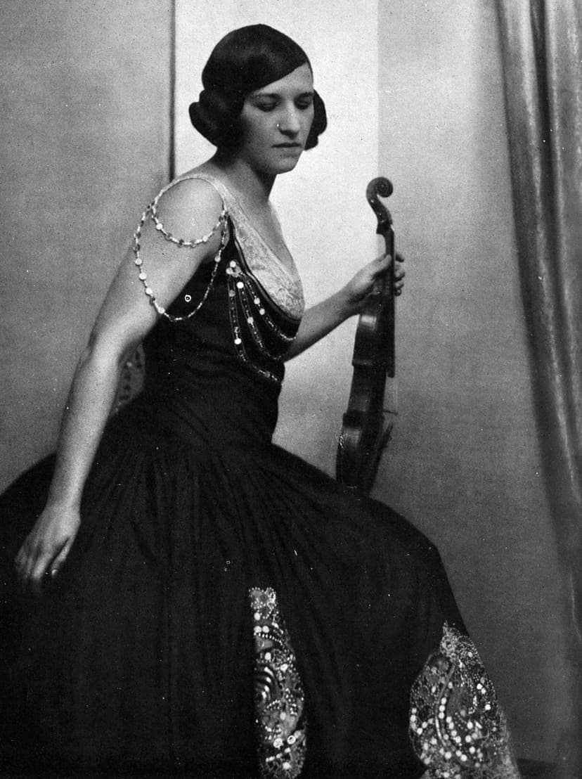 A black and white photo of a woman holding a violin