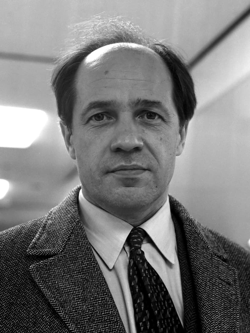 A black and white photo of a man in a suit