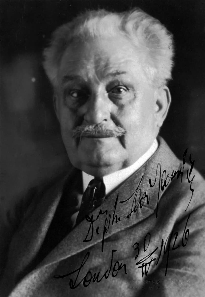 A black and white photo of a man with a mustache