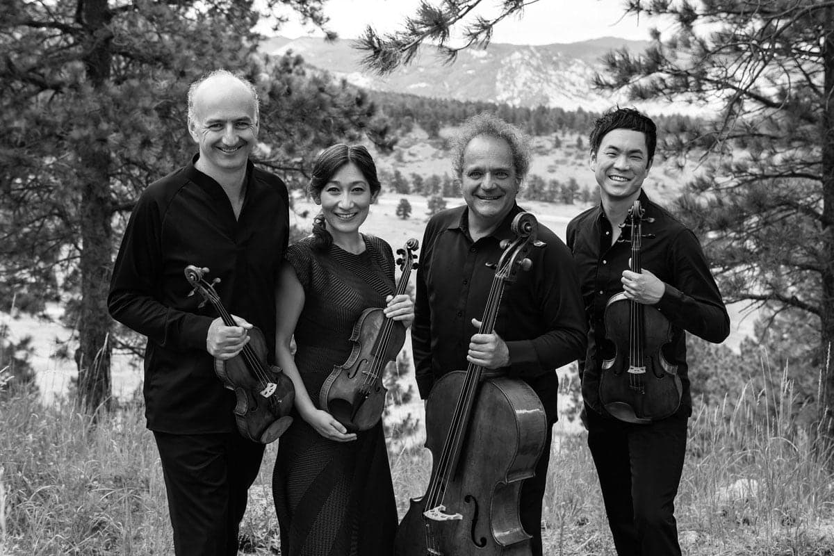 A group of people standing next to each other holding musical instruments