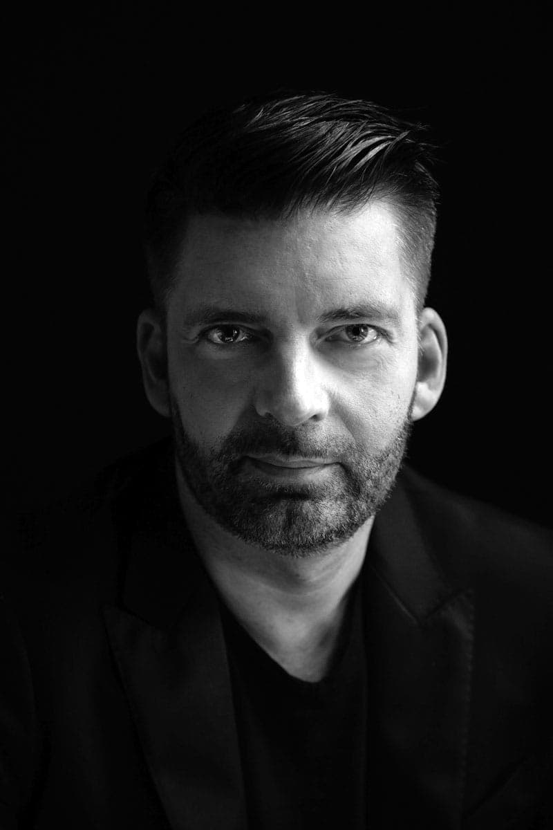 A black and white photo of a man in a suit