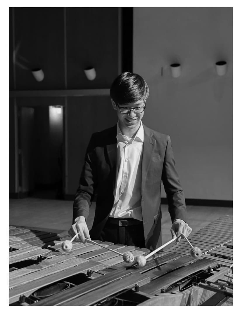 A man in a suit playing a musical instrument
