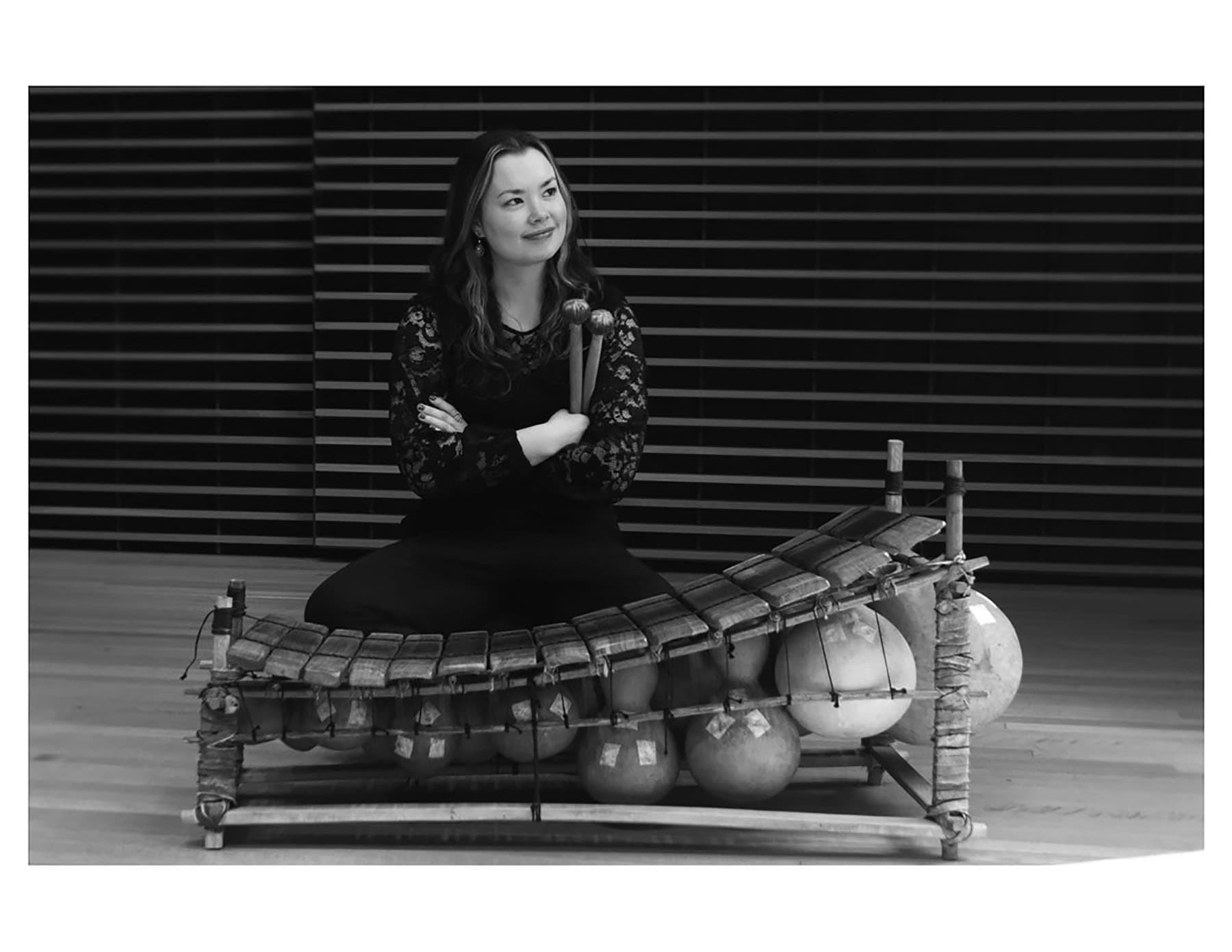 A woman sitting on top of a wooden structure