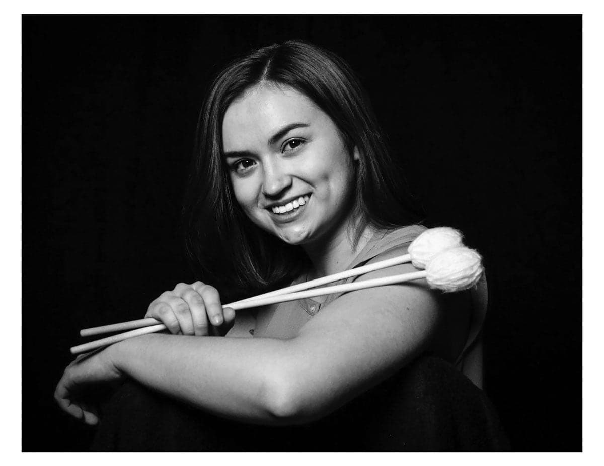 A woman holding two chopsticks in her hands