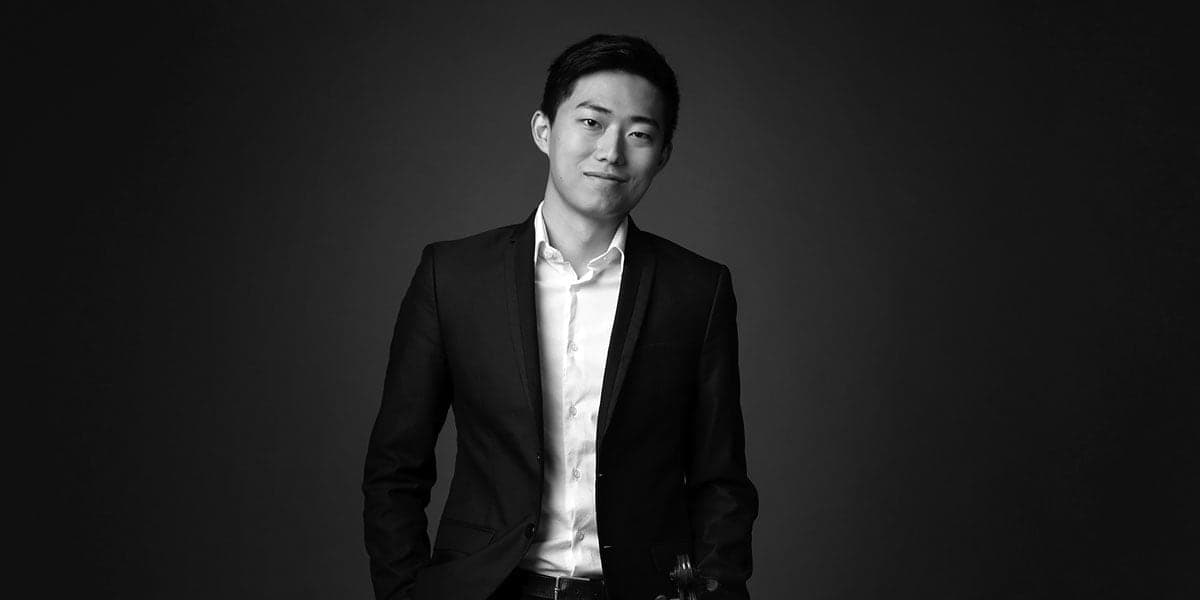 A black and white photo of a man in a suit