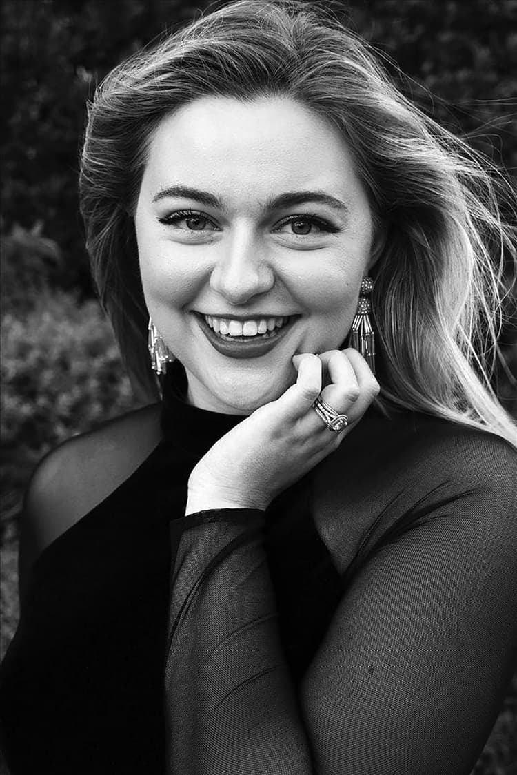 A black and white photo of a woman smiling