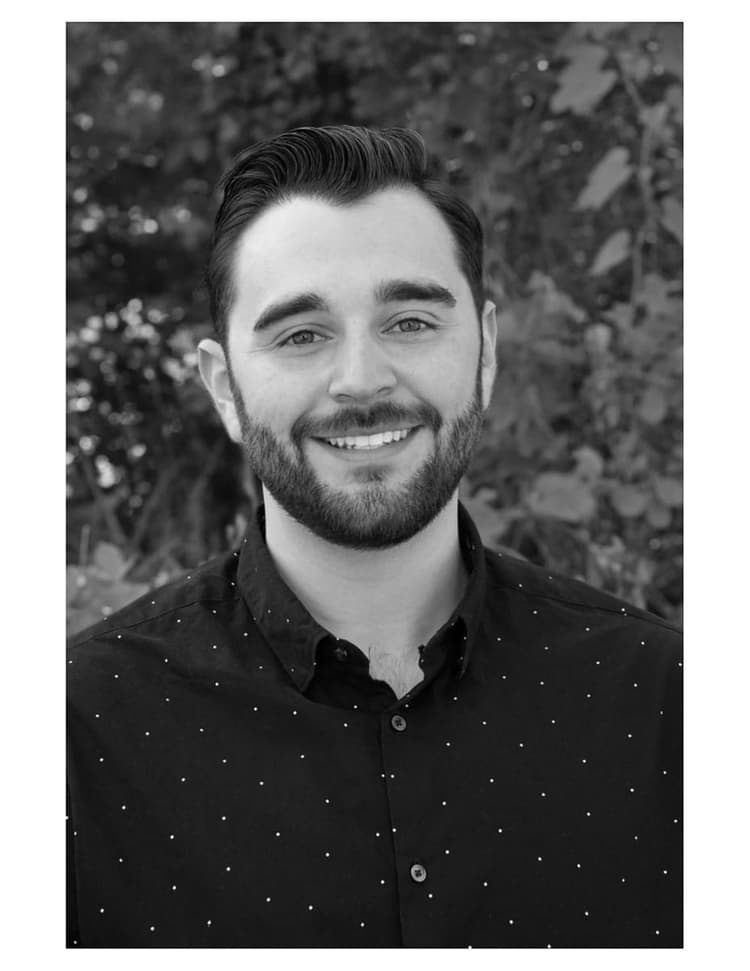 A black and white photo of a man with a beard