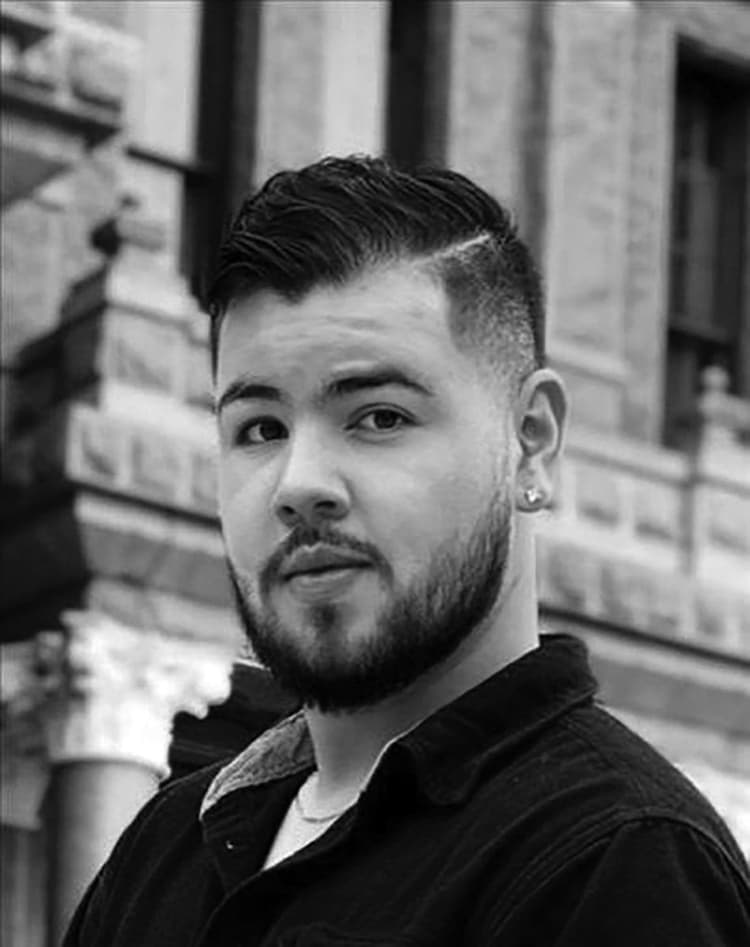 A black and white photo of a man with a beard