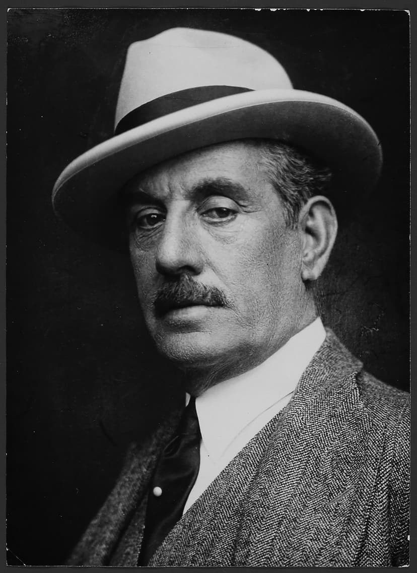 A black and white photo of a man wearing a hat