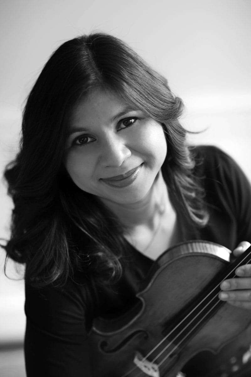 A woman holding a violin in her hands