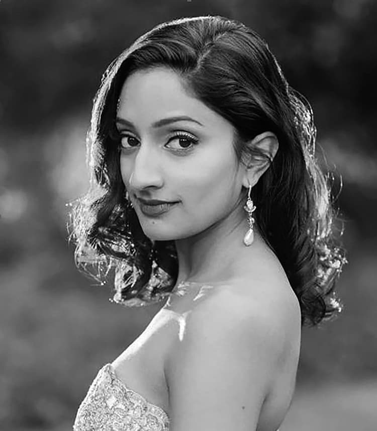 A black and white photo of a woman in a dress
