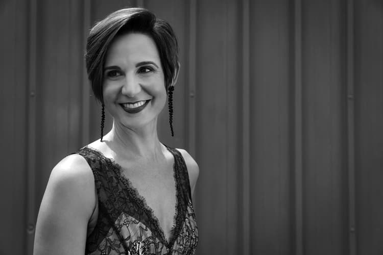 A black and white photo of a woman smiling