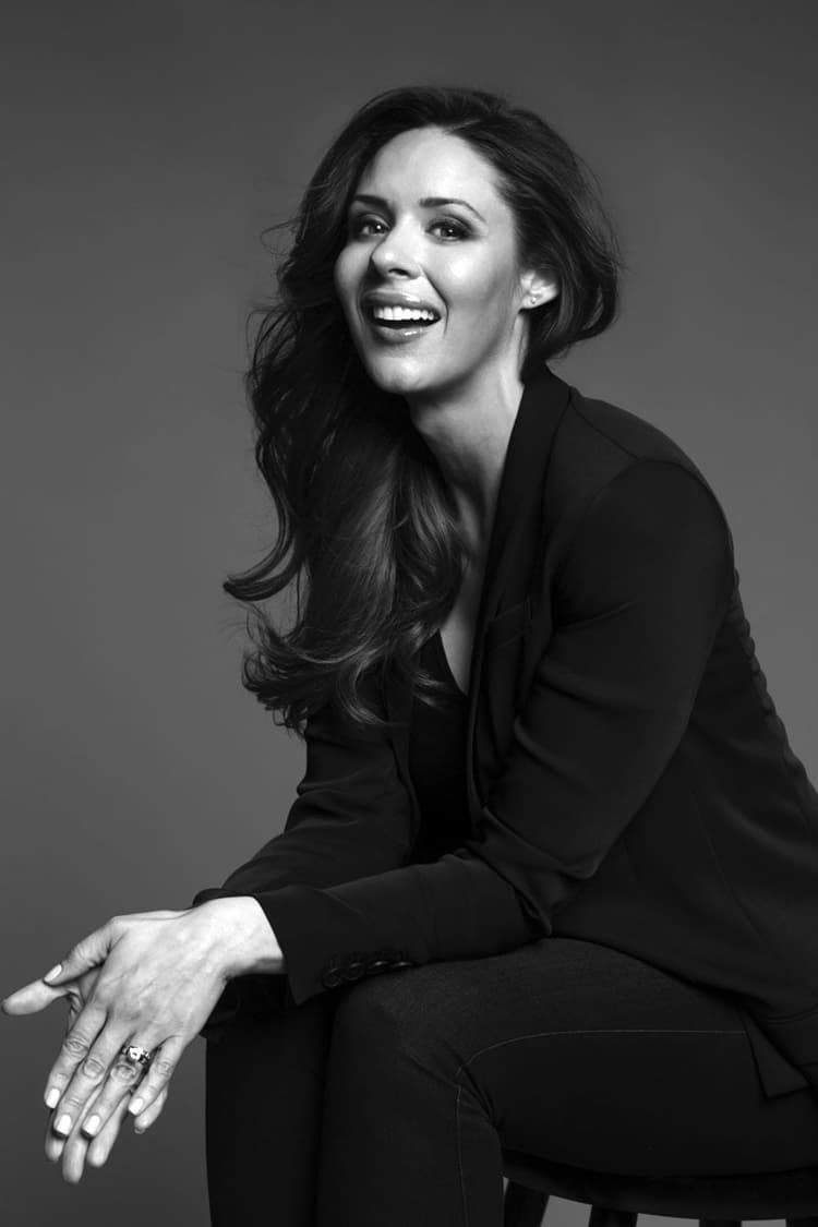 A black and white photo of a woman smiling