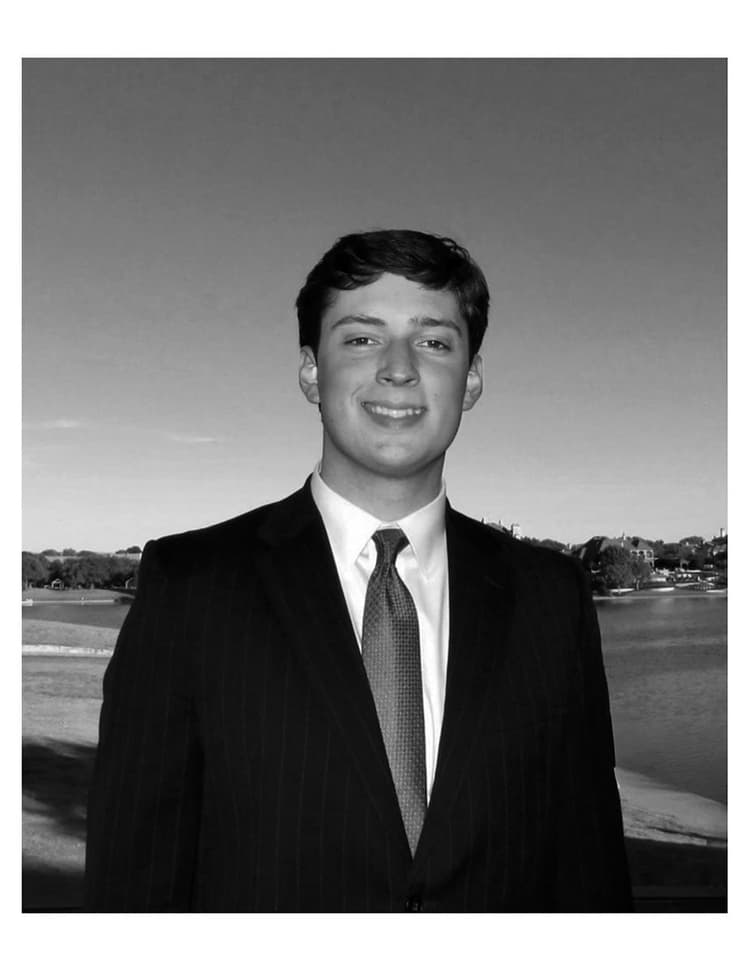 A black and white photo of a man in a suit