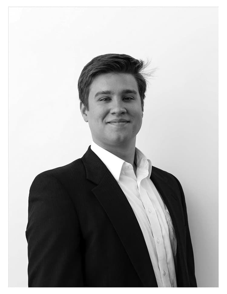 A black and white photo of a man in a suit