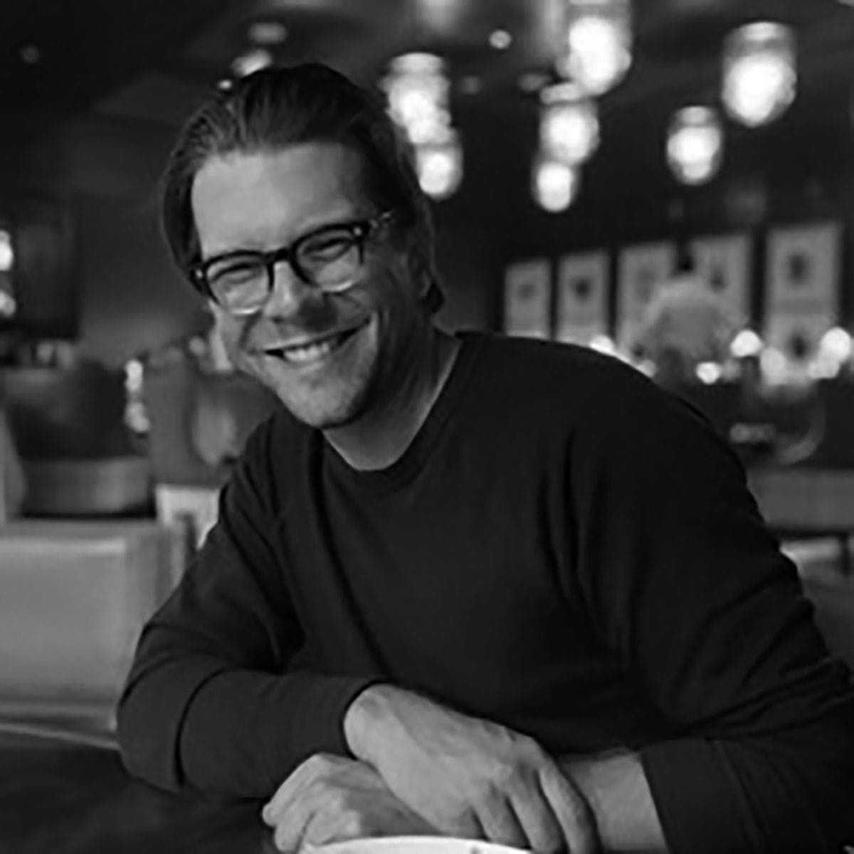 A man sitting at a table with a plate of food