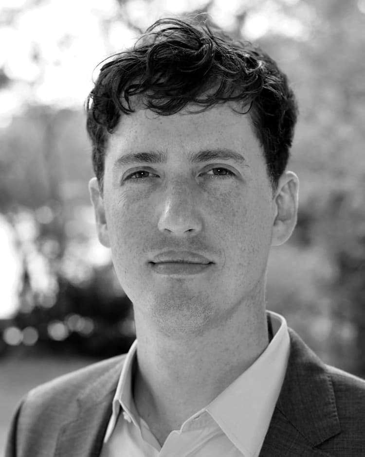 A black and white photo of a man in a suit