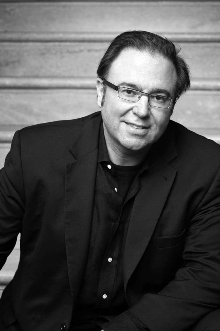 A black and white photo of a man in a suit