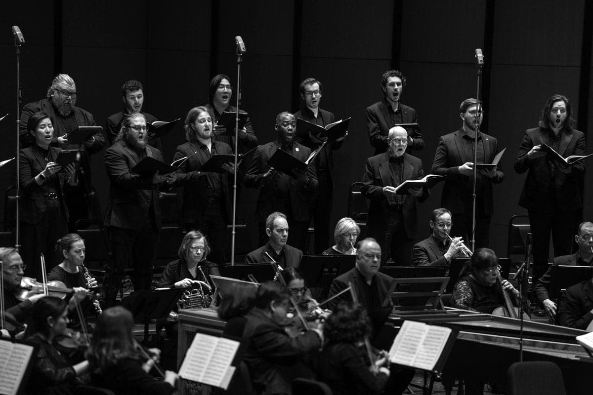 A group of people that are standing in front of musical instruments