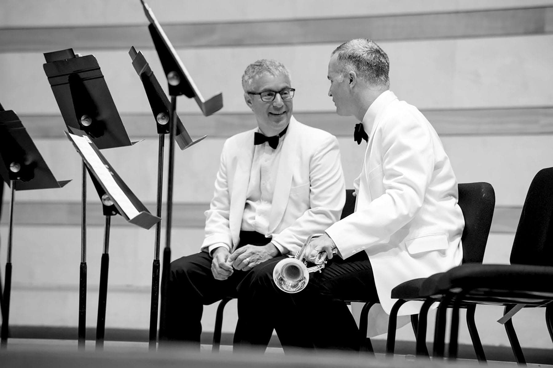 A couple of men sitting next to each other