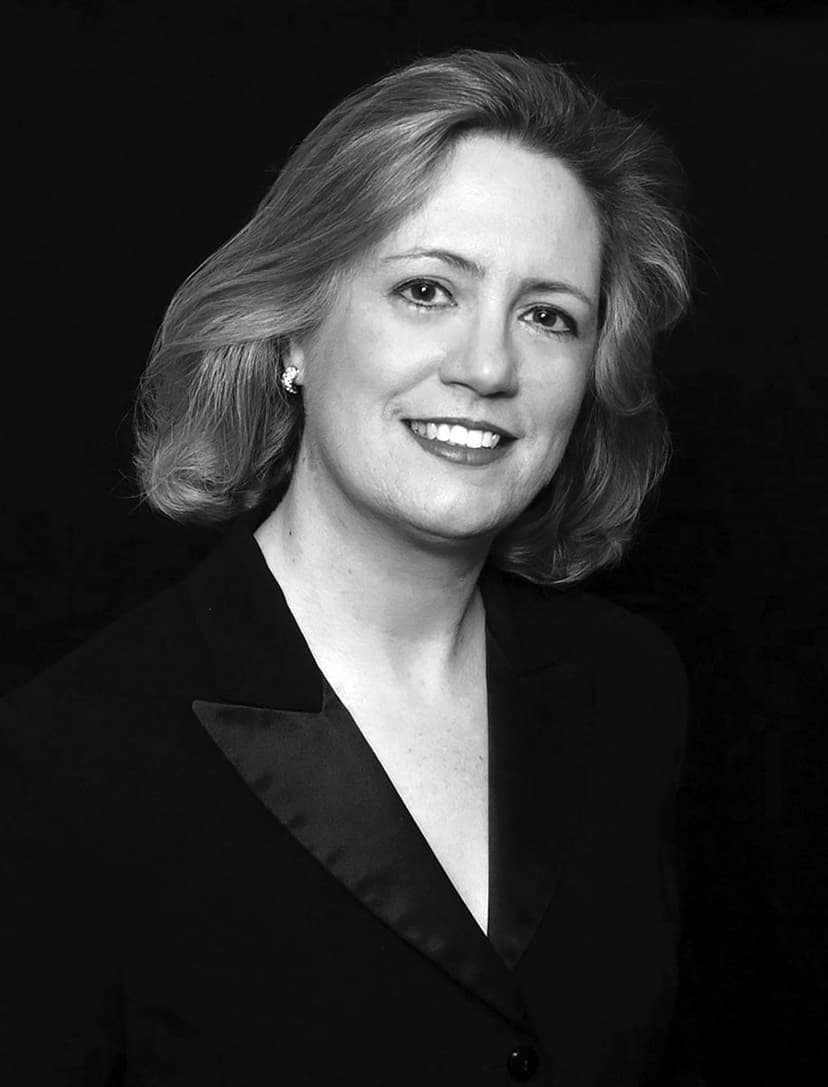 A black and white photo of a woman in a suit