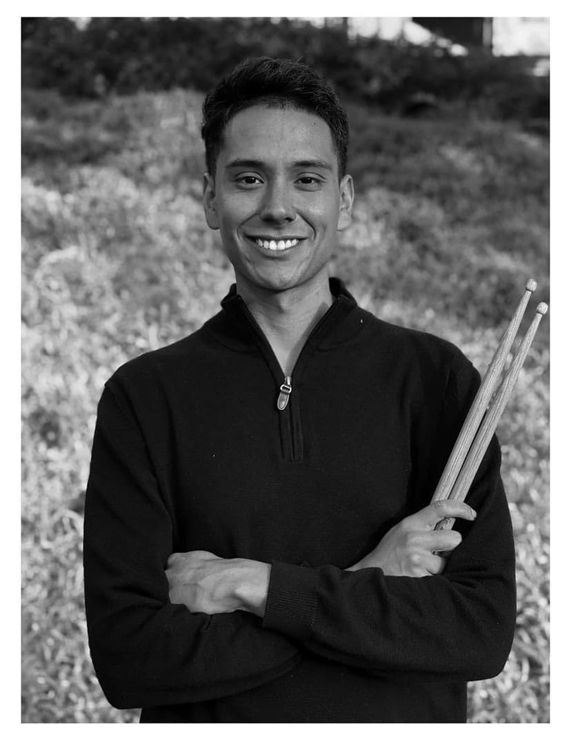 A black and white photo of a man holding two baseball bats