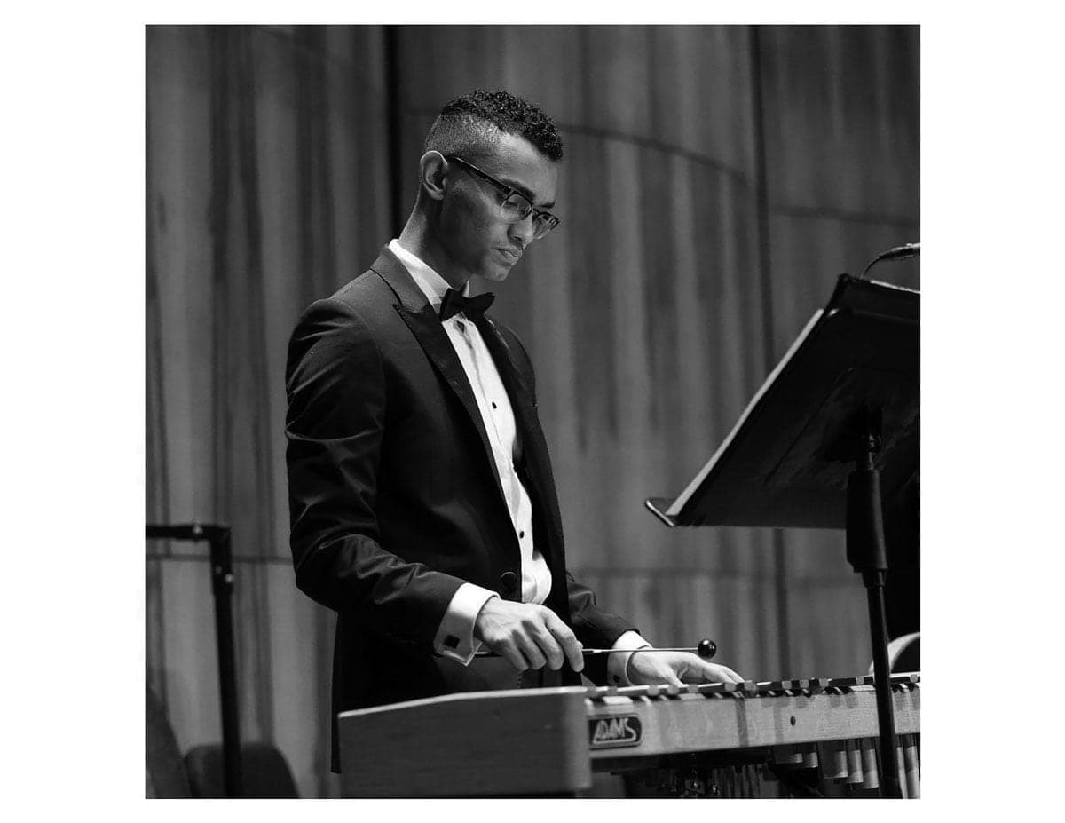 A man in a tuxedo playing a keyboard